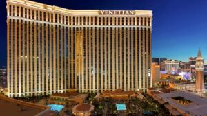 View of the golden exterior of the Venetian at night with its lights on in Las Vegas, Nevada, USA