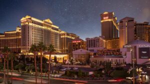 Wide shot of Caesars Palace at night with stars in the sky and all of their lights on in Las Vegas, Nevada, USA