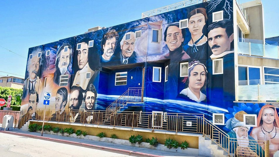 Ground view looking up at a mural of historical figures at Venice Beach in Los Angeles, California, USA