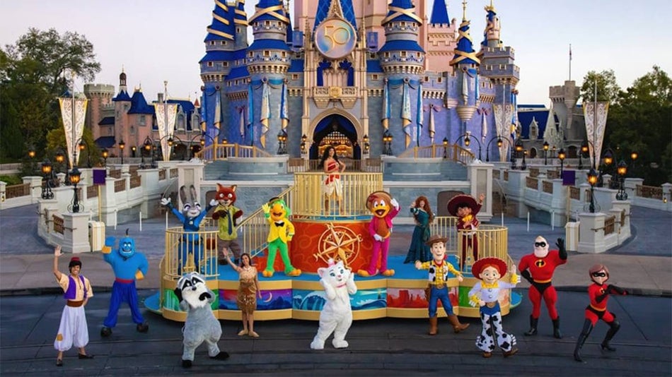 View looking down at a group of different Disney characters from Disney Adventure Friends Calvacades standing in front of Cinderellas Castle on a sunny at Walt Disney World in Orlando, Florida, USA