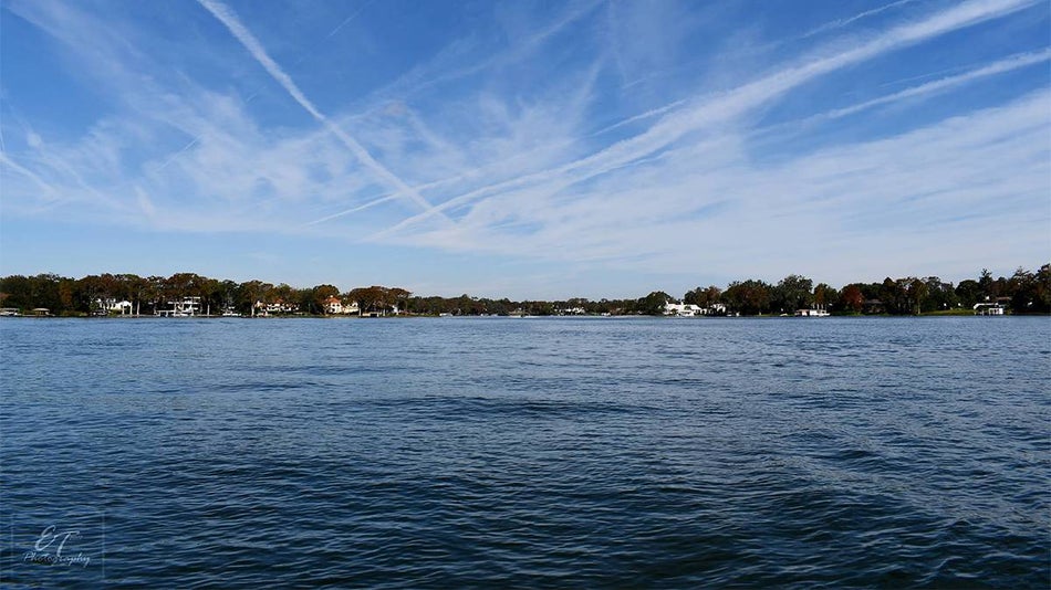Wide shot of Lake Osceola in Winter Park on a sunny day with clouds in the sky near Orlando, Florida, USA