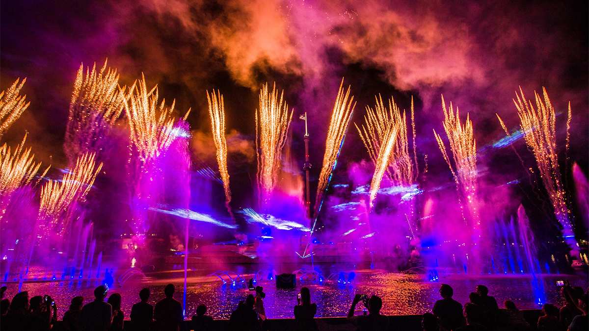 Wide shot of a light and fireworks show over the water at SeaWorld for Electric Ocean in Orlando, Florida, USA