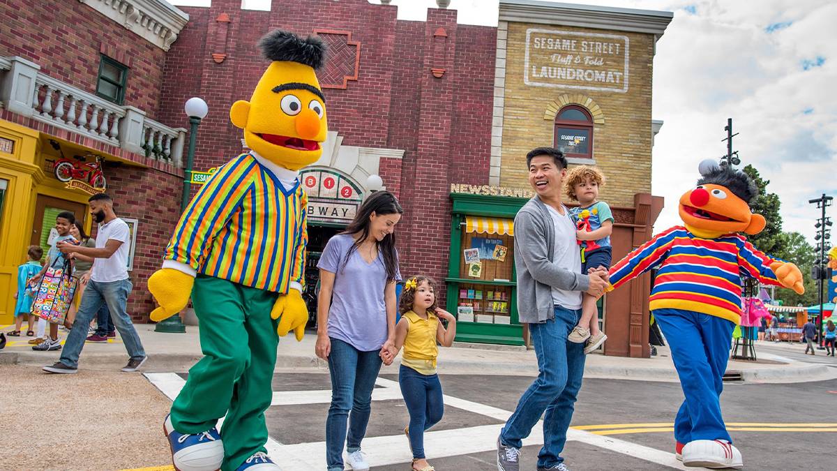 A family walking on Sesame Street with Burt and Ernie for Kid's Weekend at SeaWorld in Orlando, Florida, USA