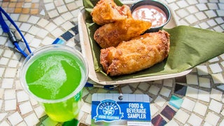 Close up of Rueben Egg Rolls and a green beer on a mosaic table for St. Patrick's Day during the Seven Seas Food Festivals at SeaWorld in Orlando, Florida, USA