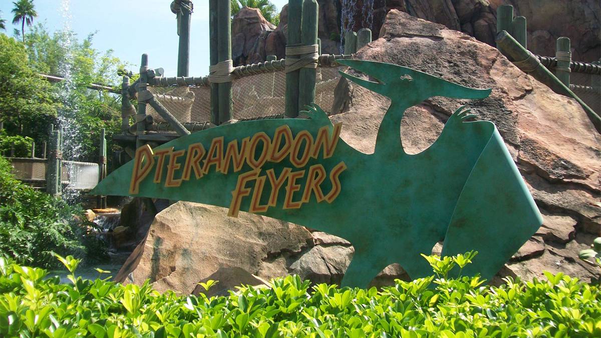 Close up of the sign for Pteranodon Flyers with a large rock behind it at Universal Orlando in Orlando, Florida, USA