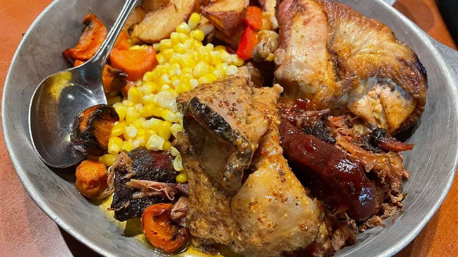 Close up of an entree from Whispering Canyon Cafe, a bowl with different types of meat and vegetables, in Orlando, Florida, USA