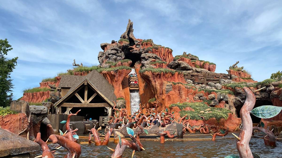 Wide shot of people in a cart going down Splash Mountain on a sunny day in Orlando, Florida, USA