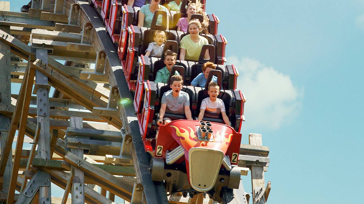 Close up of the Lightning Rod coaster at Dollywood full of people going down hill on a sunny day in Pigeon Forge, Tennessee, USA