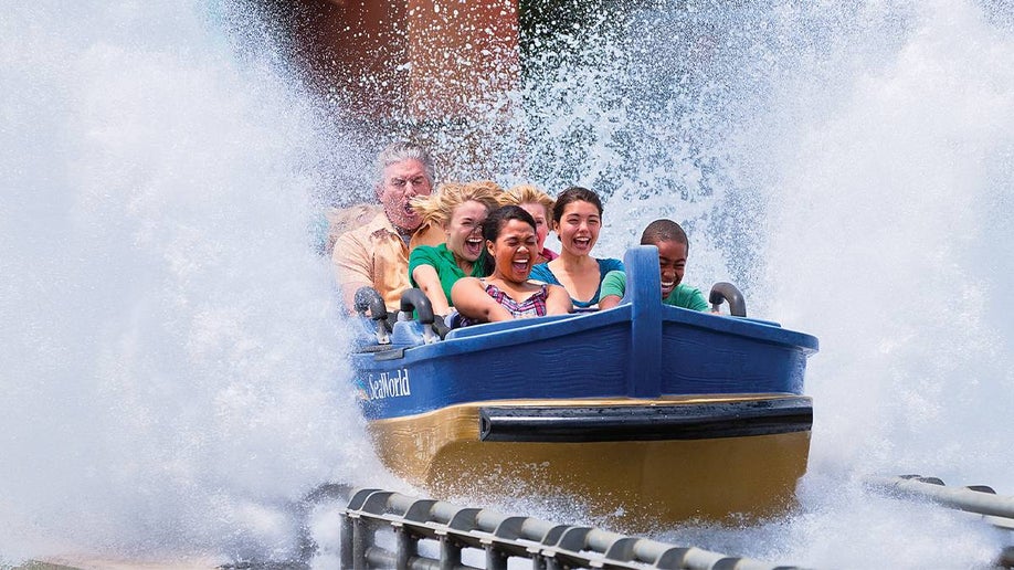 Close up of a group of people in a boat splashing into the water on Journey to Atlantis at SeaWorld in San Antonio, Texas, USA