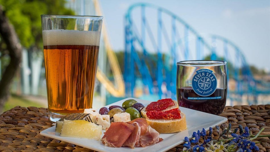 Close up of a cup of beer, a glass of wine, and a plate of snacks for the Seven Seas Festival at SeaWorld San Diego, Texas, USA