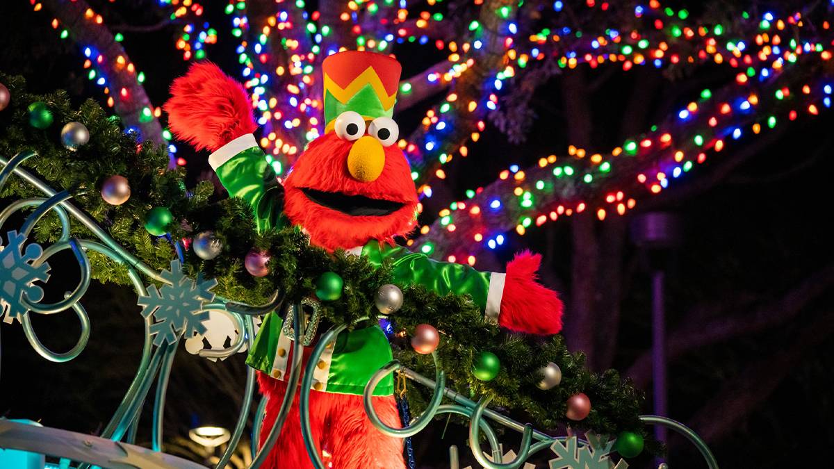 Close up of Elmo dresses at a Nutcracker with a tree covered in lights behind him as part of the Christmas Celebration at SeaWorld in San Antonio, Texas, USA