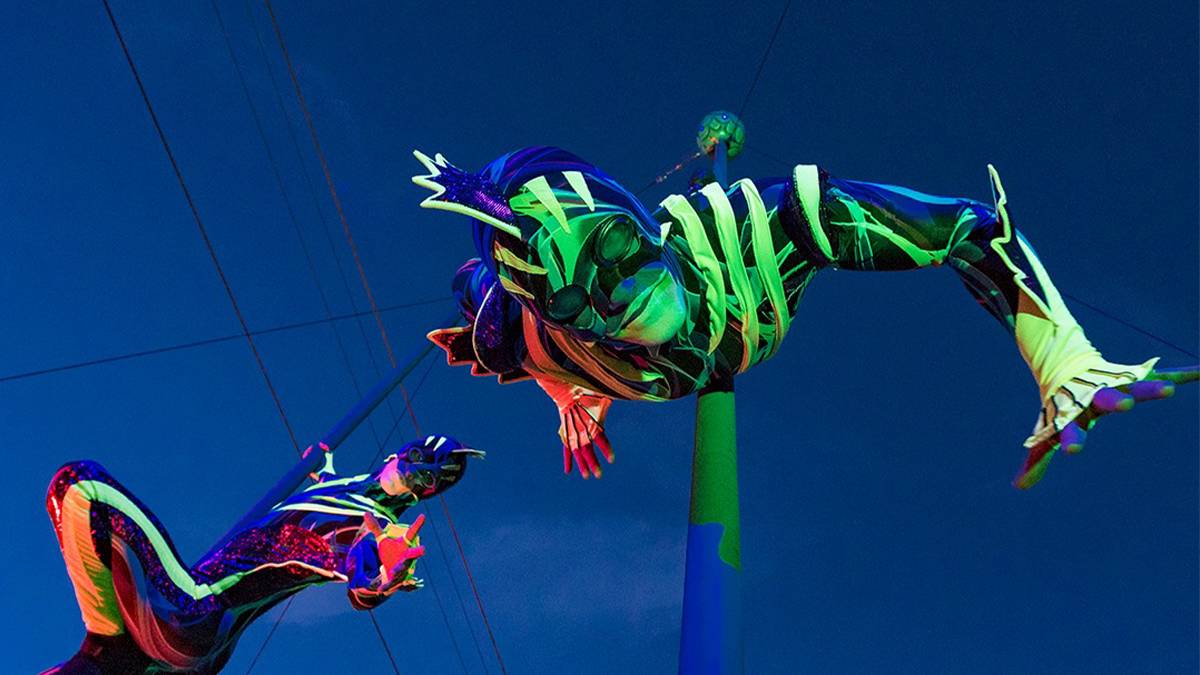 Close up of a performer hanging upside down in an eel costume during Electric Ocean at SeaWorld in San Diego, California, USA
