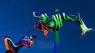 Close up of a performer hanging upside down in an eel costume during Electric Ocean at SeaWorld in San Diego, California, USA