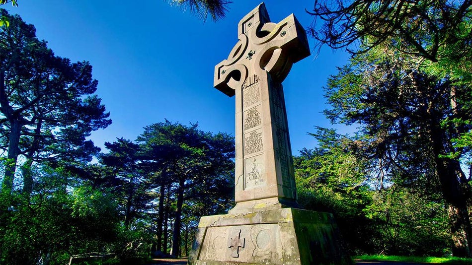 Close up of Golden Gate Park Prayer Book Cross, a giant stone cross surrounded by trees in San Francisco, California, USA