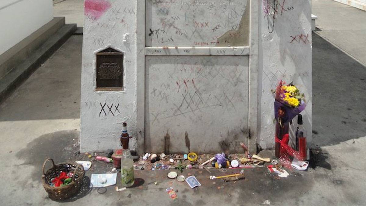 close up of tomb with x markings and various offerings at tomb of Voodoo Queen Marie Laveau in New Orleans, Louisiana, USA