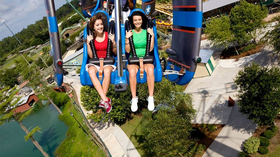 Close up of two young women on a roller coaster at Wild Adventure Theme Park in Valdosta, Georgia, USA